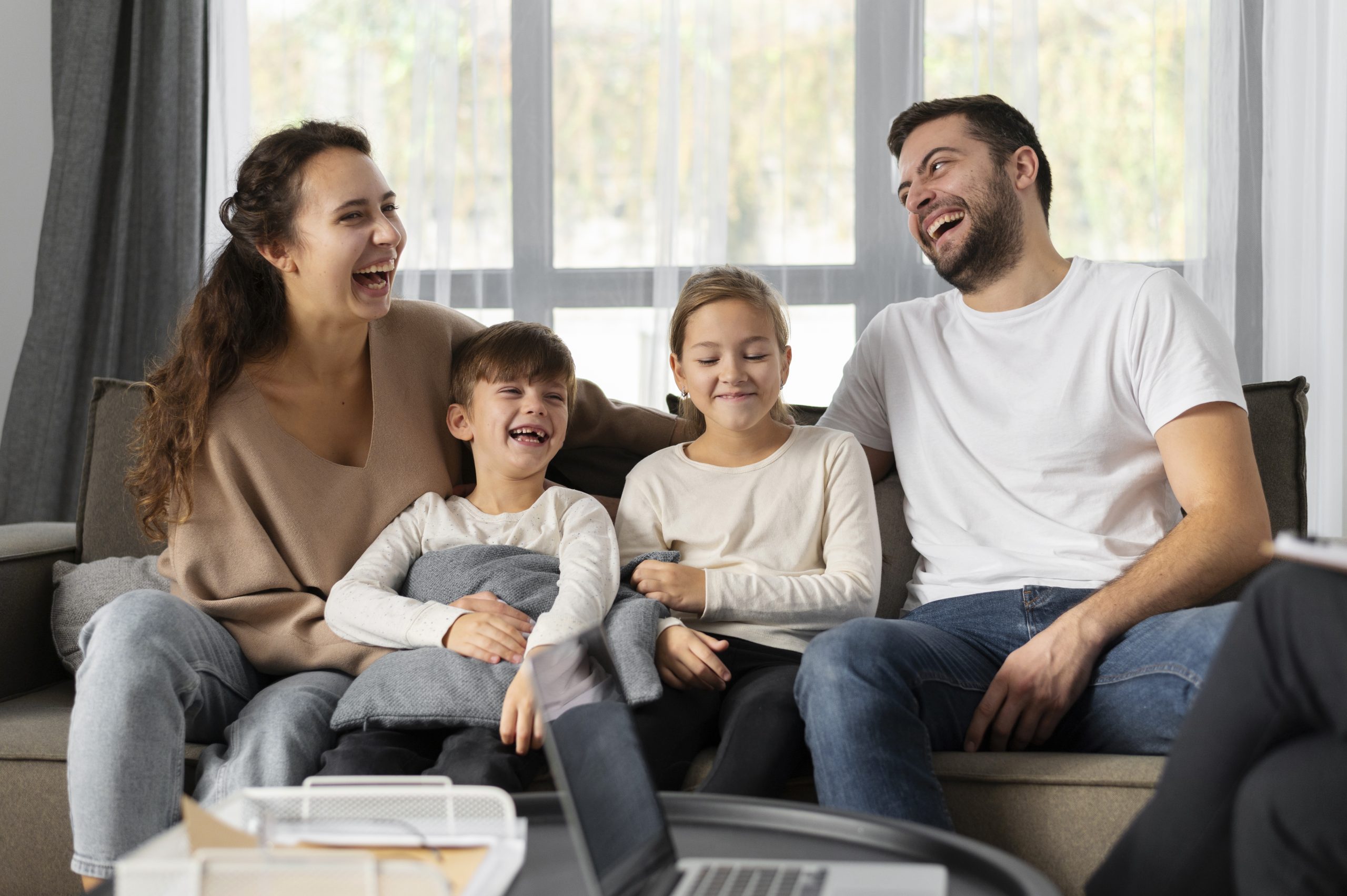 medium-shot-smiley-family-sitting-couch